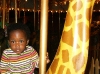 Eden riding Twiga on the merry-go-round