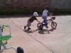 Andy pushing Eden on her bike