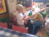 Andy having tea with the stuffed animals